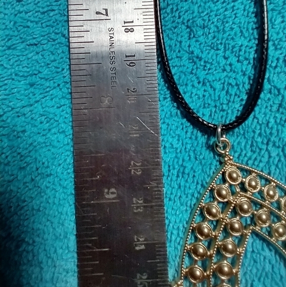 Goldtone intricate design teardrop necklace with black cord - Picture 3 of 4